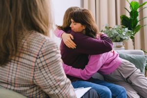 A couple hugging after successful marital mediation.